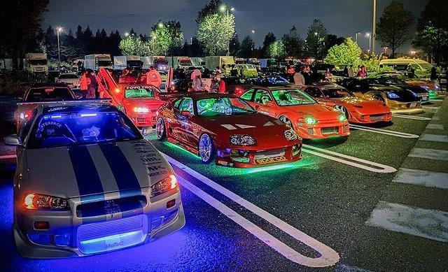 A car meet at Daikoku Futo Parking Area with various Japanese and imported cars.