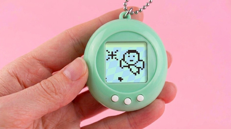 Hand holding a small digital pet device