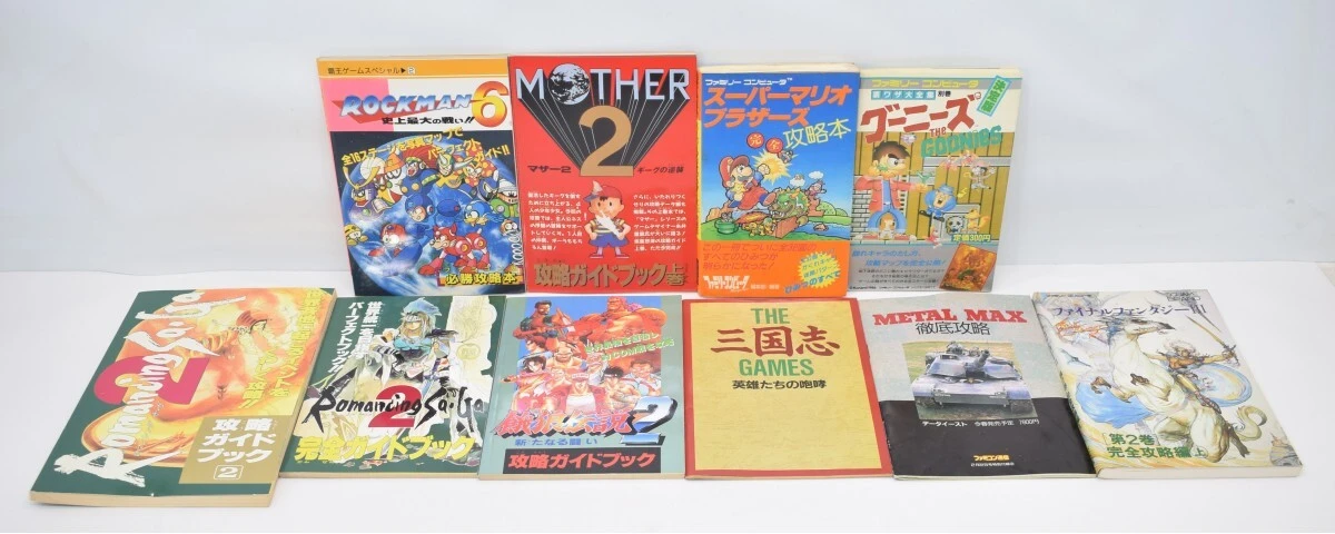 Large collection of 10 strategy guides for the FC (Famicom) series, including Super Mario Bros., The Goonies, Mother 2, and Mega Man games
