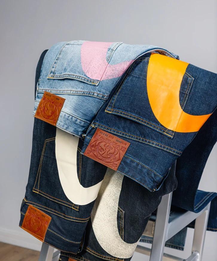 evisu jeans draped over a chair