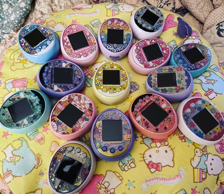 A bunch of colorful tamagochi laid down on the floor. 