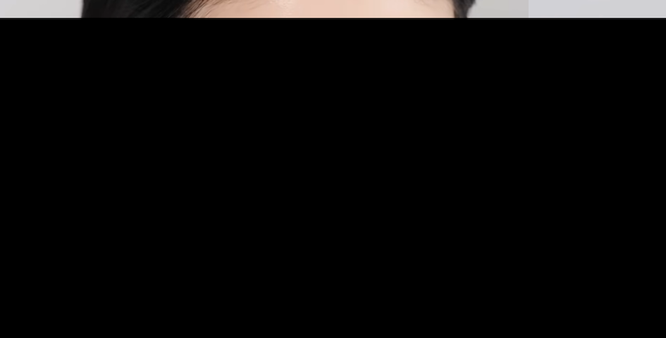 Beautiful Japanese woman with Japanese style makeup applying a clear, glossy lip oil