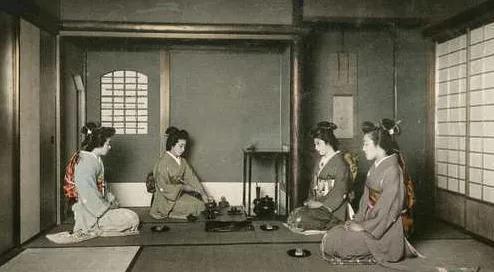 Women in kimono performing a traditional Japanese tea ceremony.