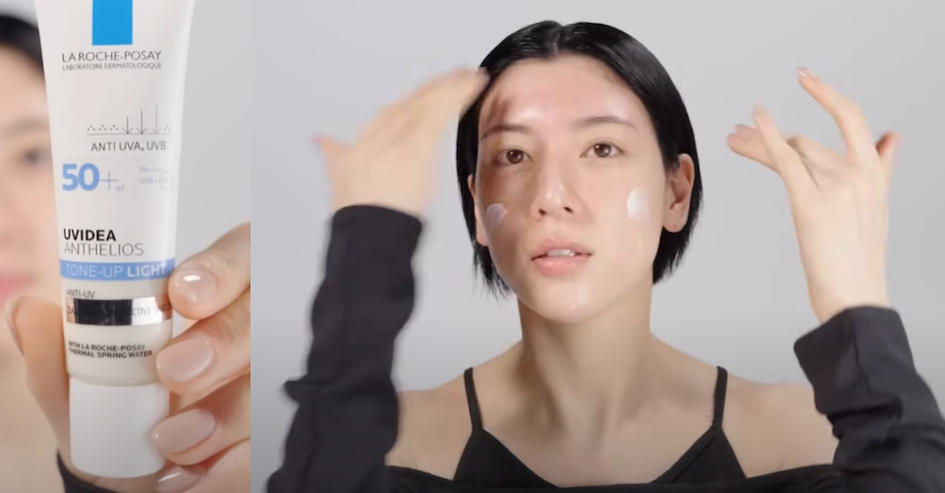 Beautiful Japanese woman with Japanese style makeup applying a SPF rich toning primer