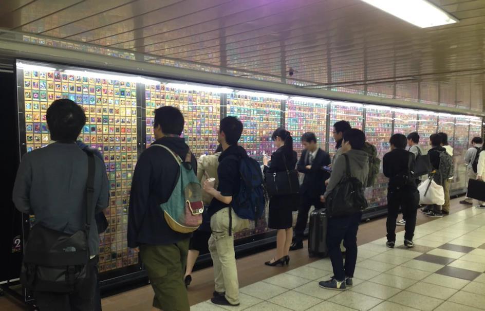 Photo of many people viewing a large display of Yu-Gi-Oh! cards in Japan