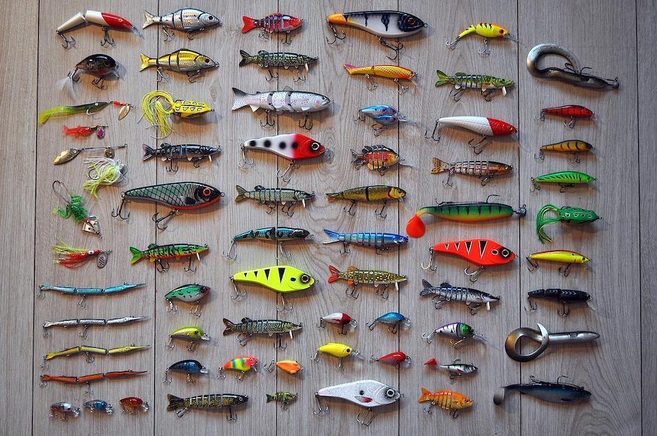 A group of fishing lures on a wall